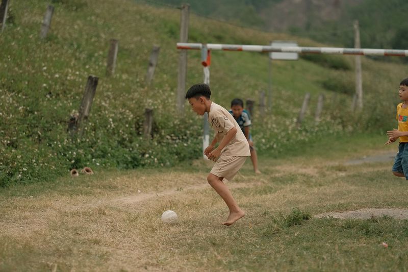 children playing soccer grass