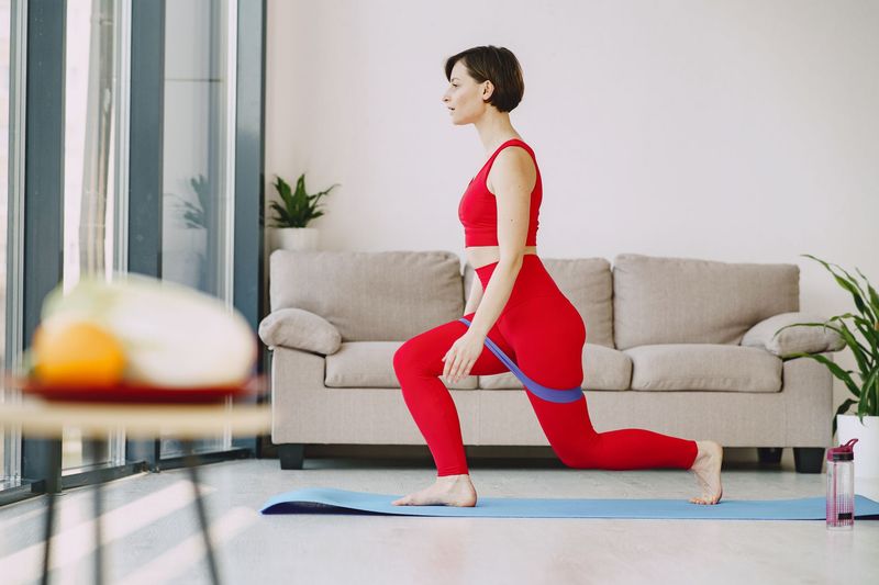woman exercising resistance band living room
