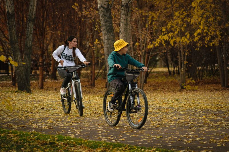 parent cycling child bike park