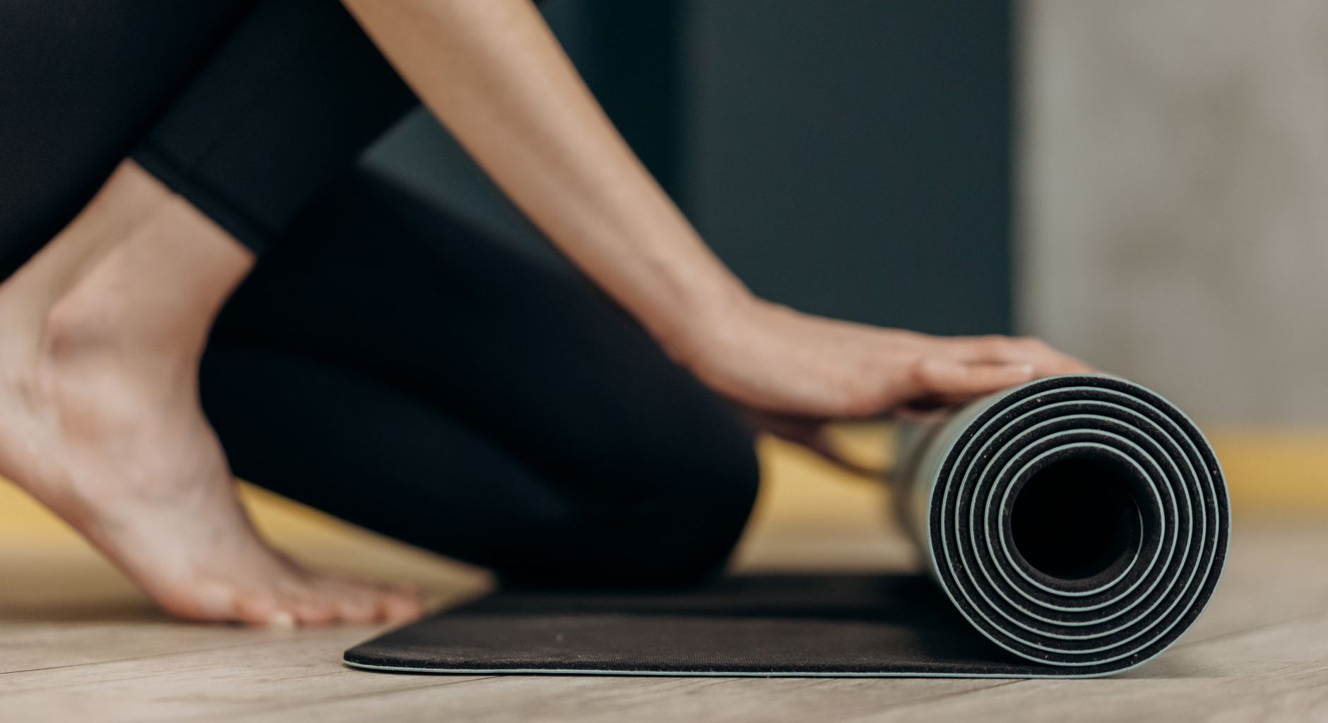 Woman on yoga mat home postnatal routine