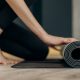 Woman on yoga mat home postnatal routine